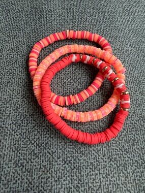 Stack of Vibrant Pink & Red Disc Stretch Bracelets